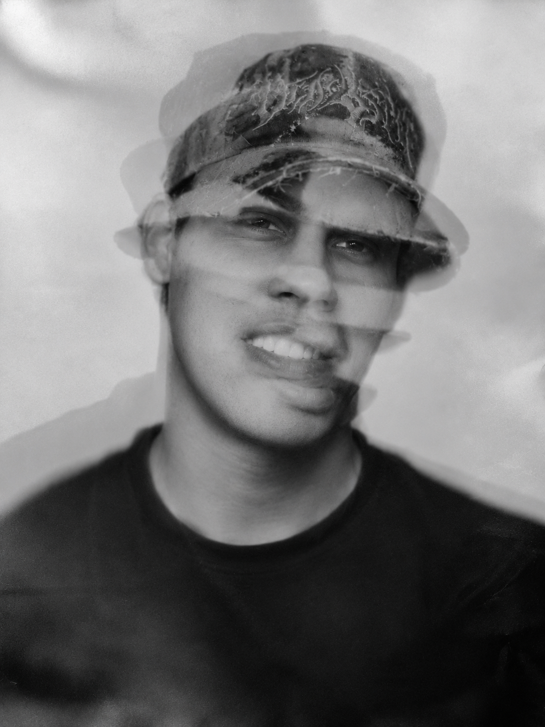 Double-exposed black-and-white portrait of Alexander Ramos Dubón