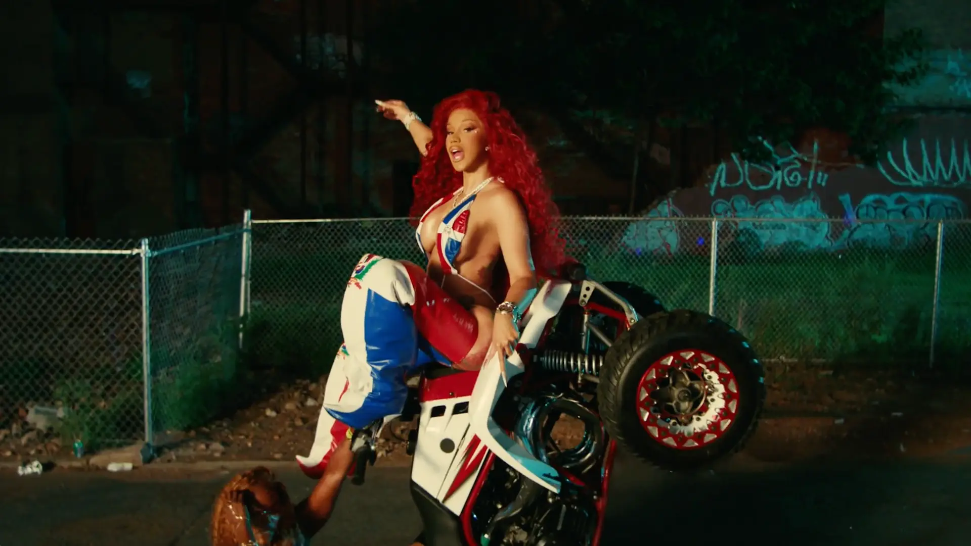 Cardi B performing on an ATV at night